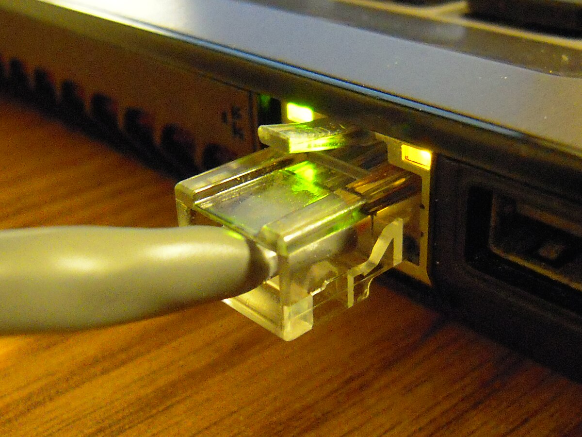 A computer with a network cable plugged into it.