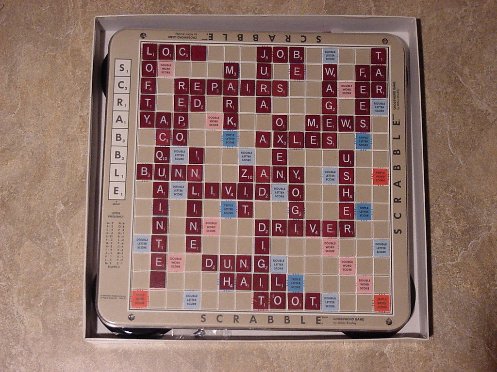 Scrabble board with the word 'EXED' spelled out