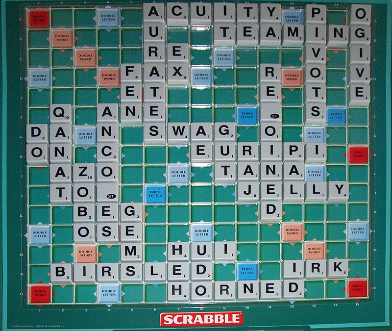 Scrabble board with the word 'EXING' on it