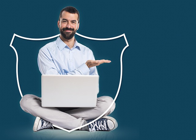A man sitting cross-legged with a laptop framed by a shield outline