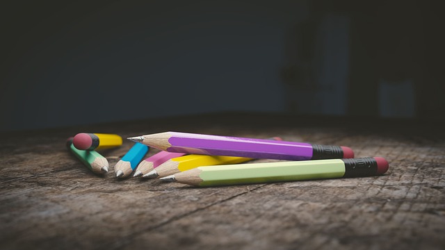 Colorful pencils lying on a wooden surface