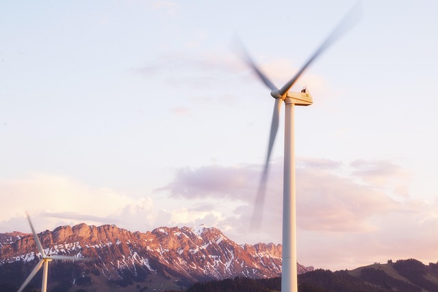 Wind turbines spinning in a landscape with mountains