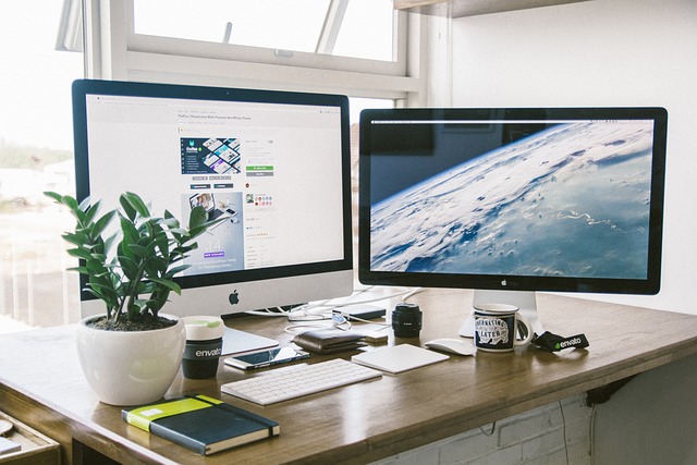 A dual-monitor computer setup on an office desk