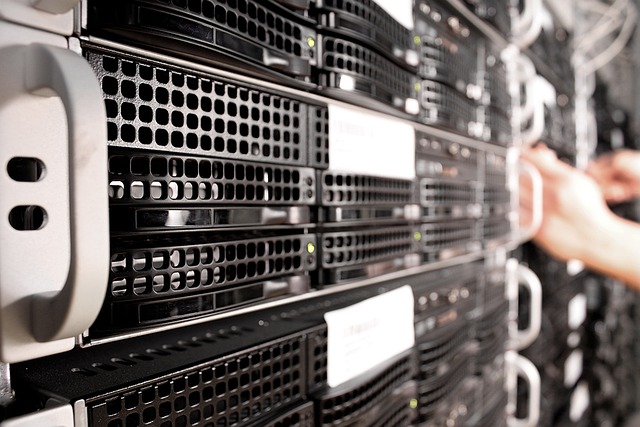 Server racks in a data center being accessed by hands
