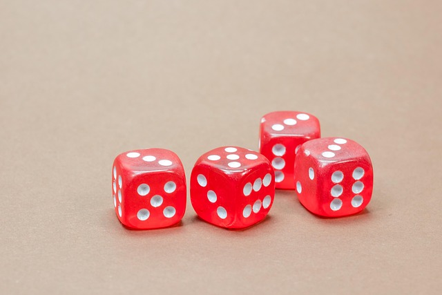 Four red translucent six-sided dice on a plain background