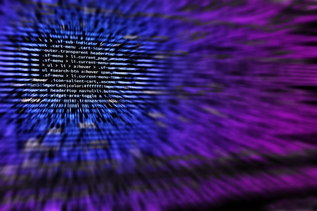 A programmer reviewing lines of code on a computer screen
