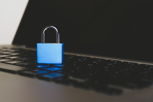 A blue padlock placed on a laptop keyboard