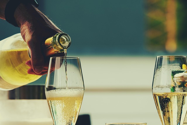A person pouring champagne or wine into a glass