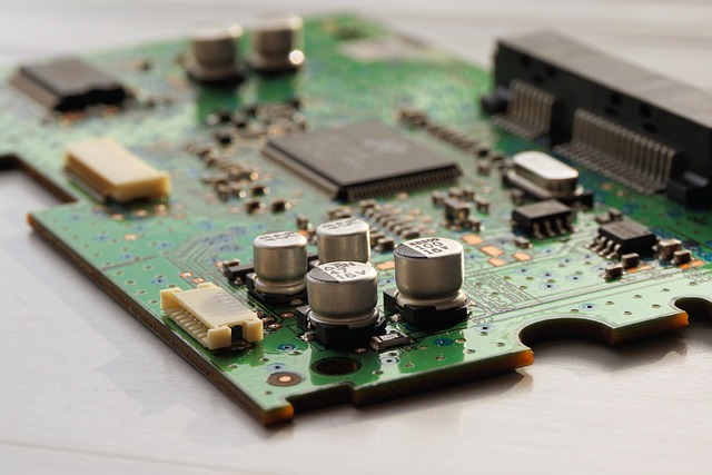 A green computer circuit board with electronic components