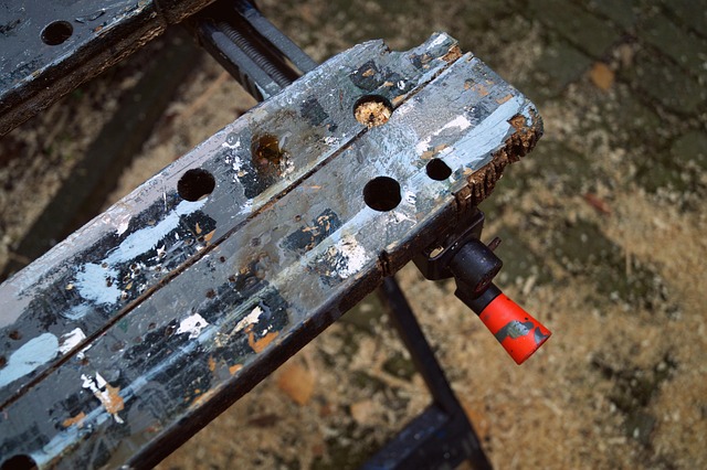 A workbench laid out with hobby tools: hobby knife, files, clippers, drill, plastic cement, and two-part epoxy putty for modelling.
