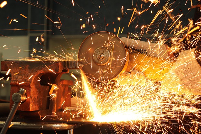 Worker polishing a metal surface to remove heat stains