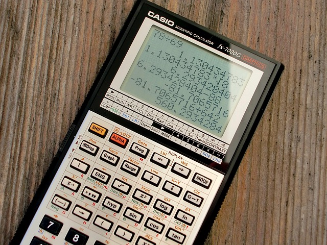 A Casio scientific graphics calculator on a wooden surface