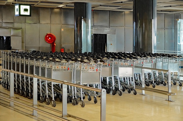 Rows of luggage trolleys inside an airport terminal