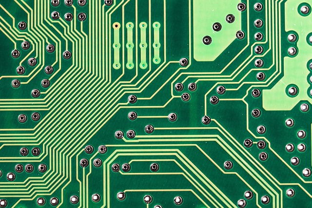Extreme close-up of green printed circuit board traces and vias